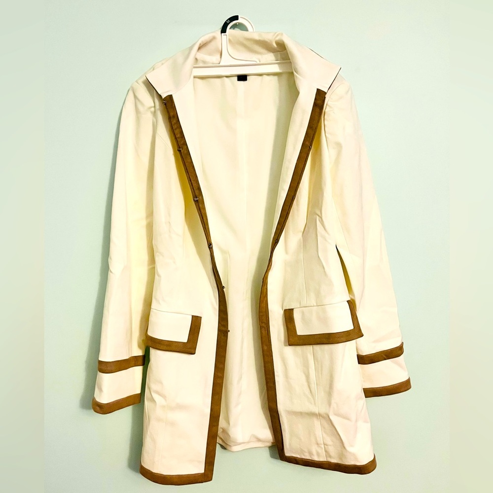 Beautiful cream white with soft brown outline jacket that comes below the butt.